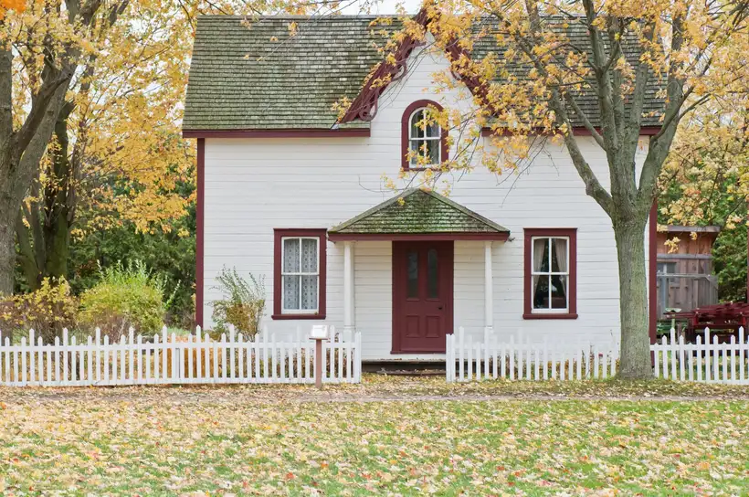 White picket fence in front of a residential home