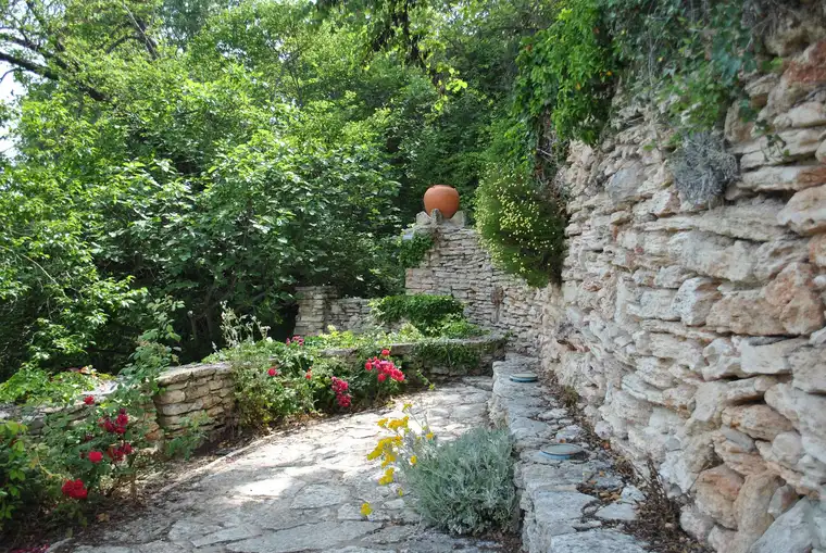 Natural stone retaining walls along a garden path