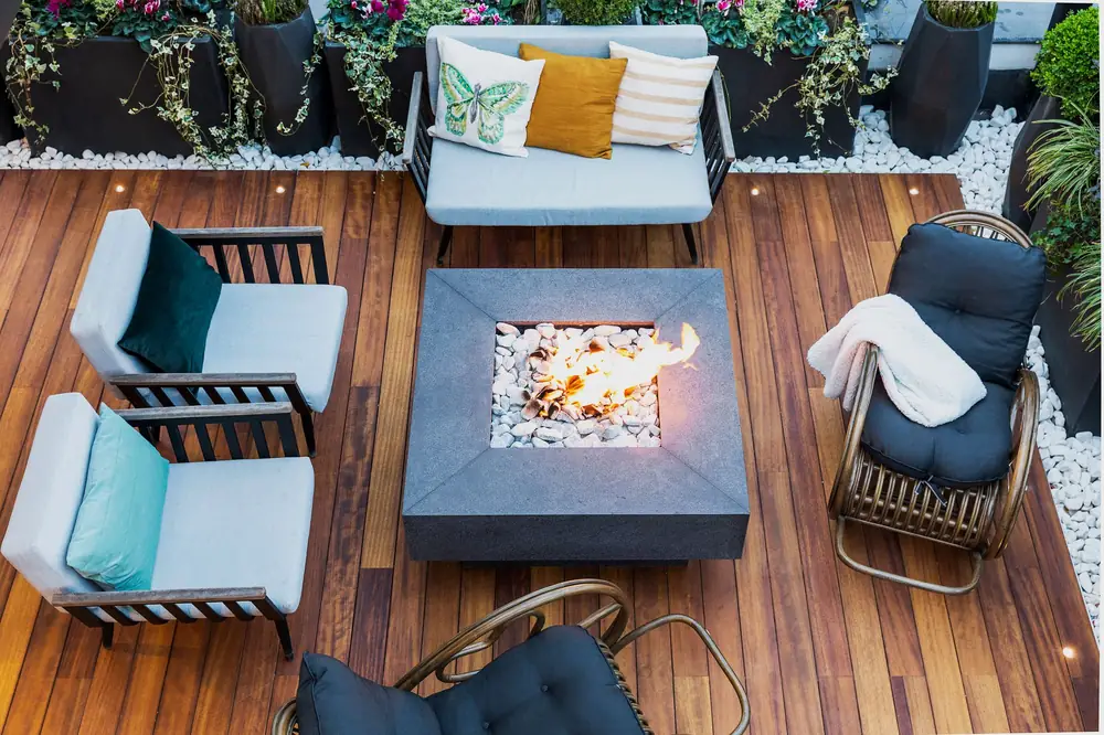 Outdoor patio seating arranged around a fire table